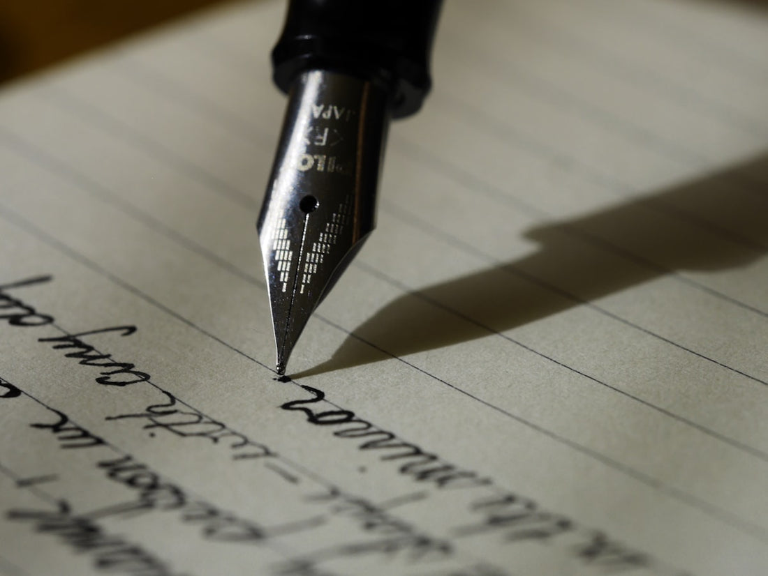 Person writing in notebook — importance of writing skills